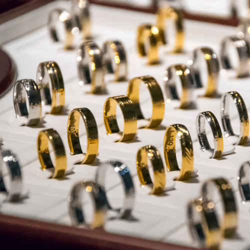 Wedding Bands Display: Gold and silver wedding bands in a display case.
