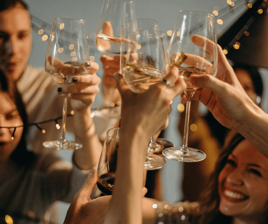 Celebration scene with hands toasting wine and champagne