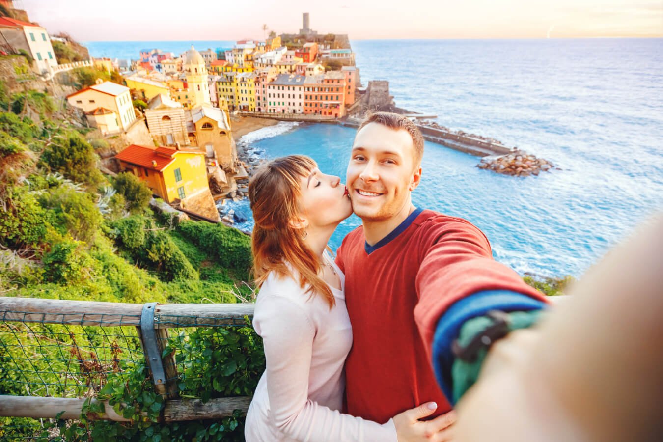 Tourists happy couple taking selfie photo of Vernazza, national park Cinque Terre, Liguria, Italy, Europe. Concept travel.