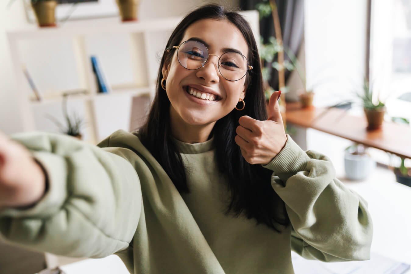 review from a young brunette woman with glasses