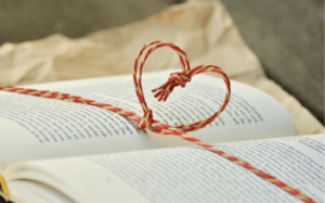 heart made of string over book pages
