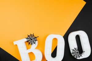 black and orange background with BOO in plastic letters